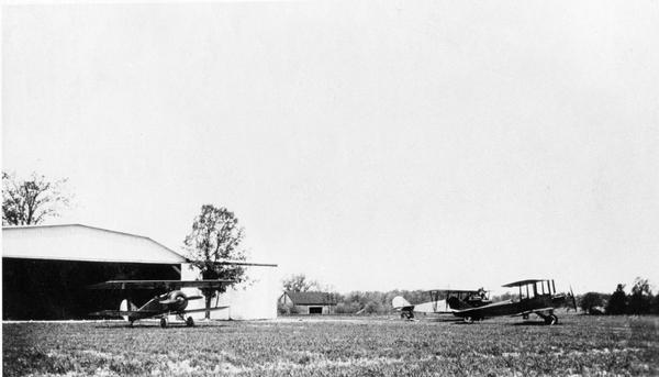The hangar and three airplanes (a Canuck and a J-1 Standard) at the airport operated by the Larson Brothers of Larsen, Wisconsin. The field was both the most famous and longest-lived rural airport in Wisconsin.