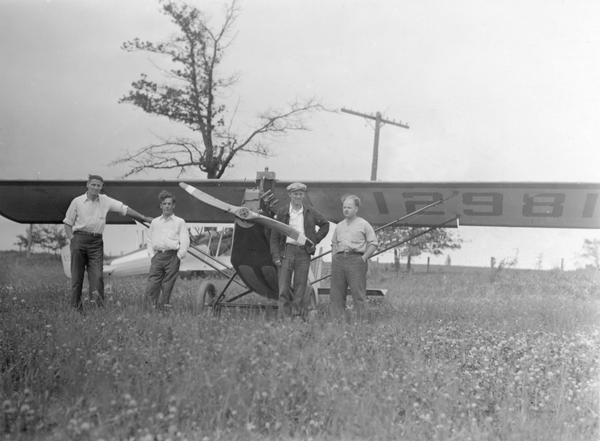 A home built Pietenpol buit by members of the Waukesha Aviation Club after its initial flight. They are Chet Wolt, Jack Leeman, Dean Crites, and Bob Lathrop. Dean Crites, one of two brothers well-known in Wisconsin aviation, had flown the test flight. Their airplane was designed by Bernard Pietpenpol to make aviation affordable for the average citizen. His planes were available as kits, parts, or plans. 

