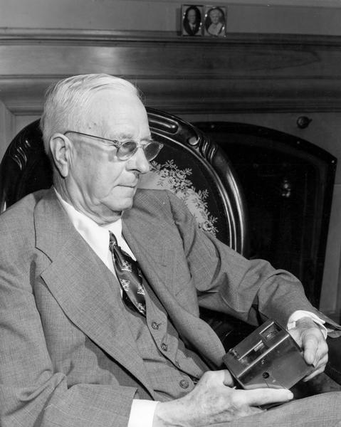 Portrait of Arthur Pratt Warner of Beloit, Wisconsin, about 1950, with a model of his first speedometer.  Even today, most automobiles are equipped with speedometers based on Warner's general design. In addition to the speedometer, Warner held over 100 patents.  He was also the first person from Wisconsin to fly a heavier-than-air aircraft (1909) and the first private individual to purchase an airplane.