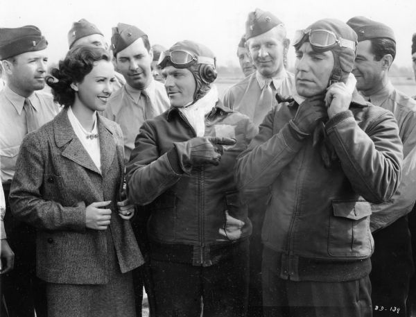 Jimmy Cagney, Pat O'Brien, and Margaret Lindsay in a publicity still from "Devil Dogs of the Air" (WB, 1935). In this production Cagney and O'Brien play two Marine Corps flyers who fall for the same girl.  Although chiefly remembered for his portrayal of priests and football coaches, Milwaukee-born Pat O'Brien also played in action adventures such as "Devil Dogs" during the 1930s and 1940s.