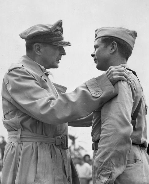 General Douglas MacArthur congratulates Richard I. Bong, World War II Ace of Aces from Poplar, Wisconsin, after awarding him the Congressional Medal of Honor at an airstrip on Leyte Island, Phillippines.