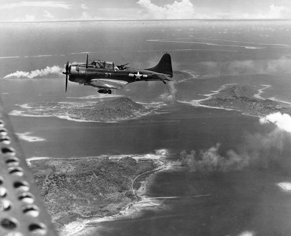 Navy SPD-1 bomber over Truk. Moen Island is in the foreground, Fefan is at the right, and Etan is directly below the plane.