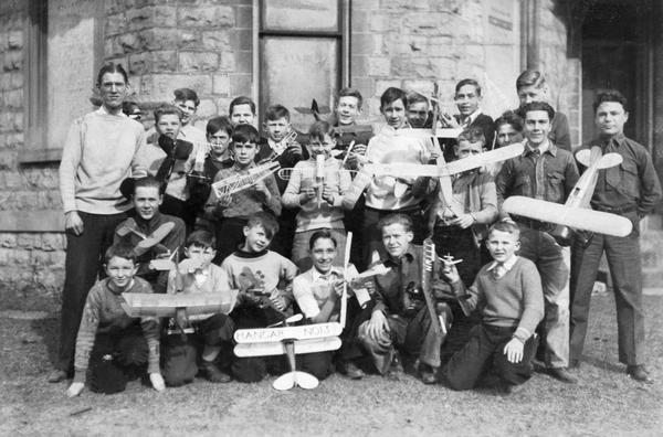 The members of Hangar 13, a group of Beloit youth organized to build and race model airplanes. Conrad Hansen, their organizer, is standing at left in the back row.