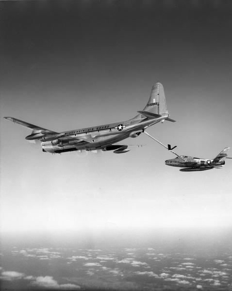A KC-97 of the 126th Refueling Squadron, Wisconsin Air National Guard, refueling an F-84 fighter over eastern Wisconsin.