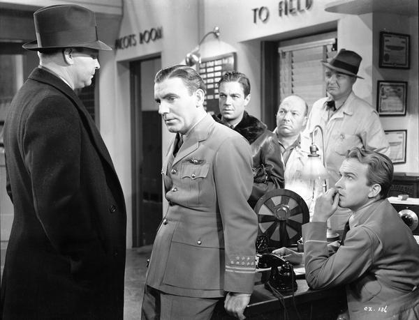 Milwaukee-born Pat O'Brien (in the pilot's uniform) starred with Jimmy Cagney as two commercial airline pilots in "Ceiling Zero." This 1936 Warner Brothers release was one of many aviation films directed by Howard Hawkes.    
