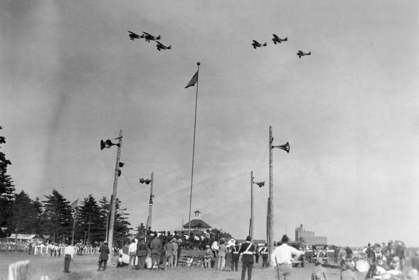 An exhibition of flying by the 1st Pursuit Squadron of the U.S. Army Air Corps. The event took place at Marathon Park because President Calvin Coolidge, who was vacationing on the Brule that summer, took a day off from his vacation to visit the annual convention of the American Legion of Wisconsin. All of the airplanes were Curtiss PIs.