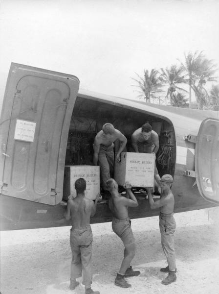 Loading crates of blood at Falalop Island.  This image is one of many taken by Milwaukee photographer Dickey Chapelle that document the care of the wounded during the latter stage of World War II in the Pacific.