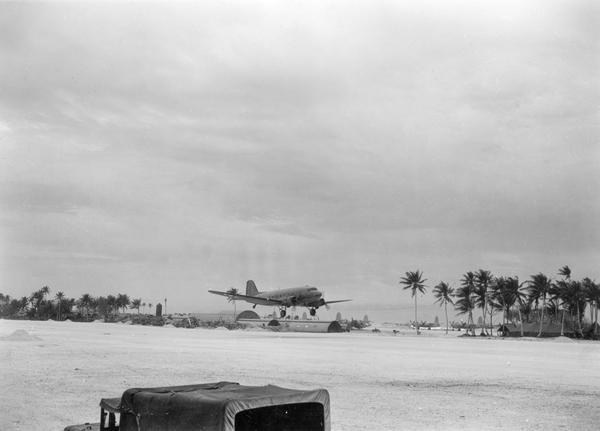 A C-47 bomber returns to North Airfield, Guam. This airfield had been operational only since early February. This image is one of many taken by Milwaukee photographer Dickey Chapelle during the final months of World War II in the Pacific.