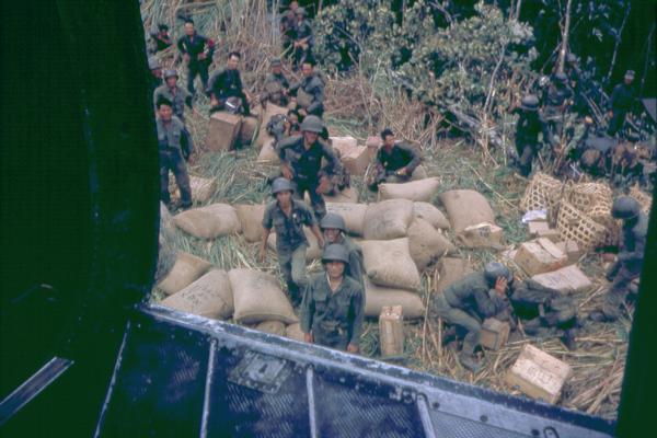 Dropping supplies at a South Vietnamese army outpost. Photographer Dickey Chapelle of Milwaukee was on board the helicopter as the drop was taking place.