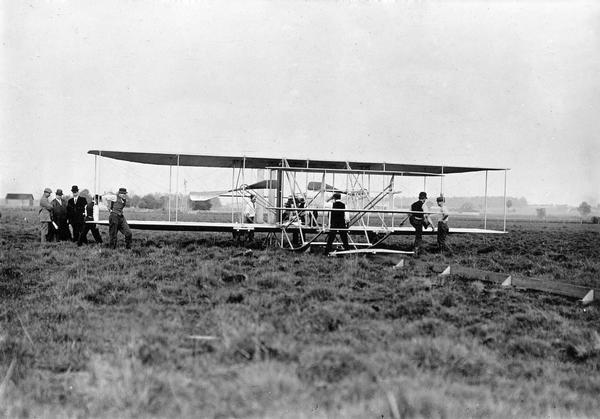 An original print of an early Wright Brothers airplane from the Arthur Pratt Warner collection. The print is unidentified, nor is there any information on how Warner obtained it, but it can be dated approximately by the fact that it is a two-seat model and that the plane was still launched on a runway.