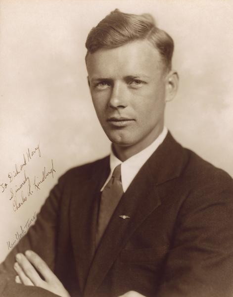 A formal portrait of aviator Charles A. Lindbergh taken at the New York Times Studio just prior to his trans-Atlantic flight because the newspaper had purchased exclusive rights to Lindbergh's story. As his publicists, Harry Bruno and Richard Blythe went along to the photo shoot, and Lindbergh later inscribed the portrait to them in appreciation of their advice and protection.