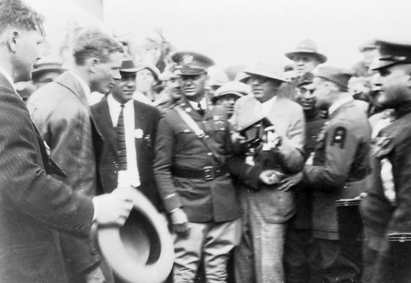 Madison admirers gather around Charles Lindbergh upon his arrival in the city. This photograph is believed to have been taken in 1928 when Lindbergh returned to receive an honorary degree from the University of Wisconsin.