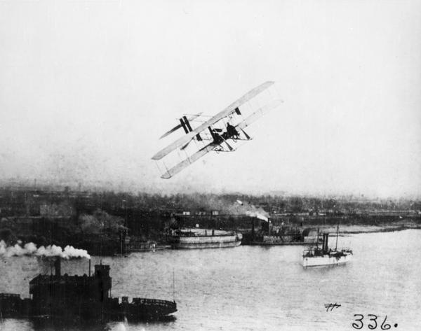 Jesse Brabazon, pioneer aviator from Delavan, flying over the Mississippi River in a Wright Model B airplane. "It was quite a sight to fly over the Mississippi River and witness the boats steaming on the river and to compare the method of transport being used at that time to the future transportation."