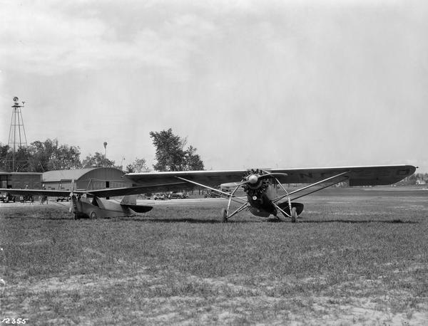 The airport at Kohler. On the ground (right) is "The Village of Kohler," the Mahoney-Ryan-Brougham owned by Walter Kohler, Sr., and Carl Kohler's Aeronica sport plane.