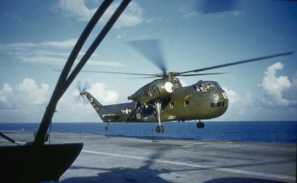 A CH-37 Mojave helicopter landing on an aircraft carrier. This helicopter type could carry 26 troops or two jeeps. It was used for aircraft recovery in Vietnam.