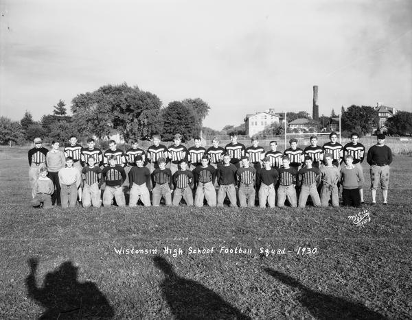 Group portrait of Wisconsin High School football squad in uniform.