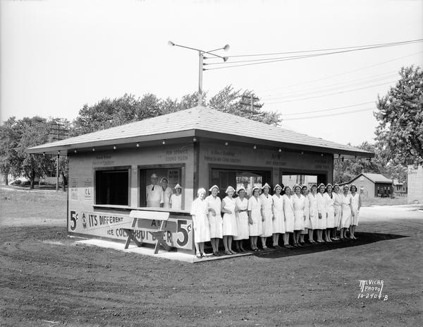 A&W Root Beer Stand at 900 South Park Street, with employees in uniforms posing inside and in front of the building.