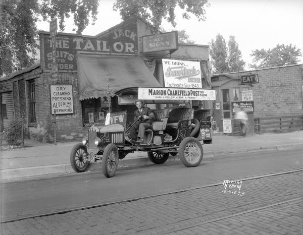 Omnibus advertising Marion Cranefield VFW Post 1318 and Fauerbach Beer. The bus is parked in front of Ferdinand C. Jack's Tailor Shop and Edward "Ace" Fischer's Sign Shop, 224-226 King Street. Next door is Mrs. Fischer's Steam Cooked Meals in a diner at 226 1/2 King Street.