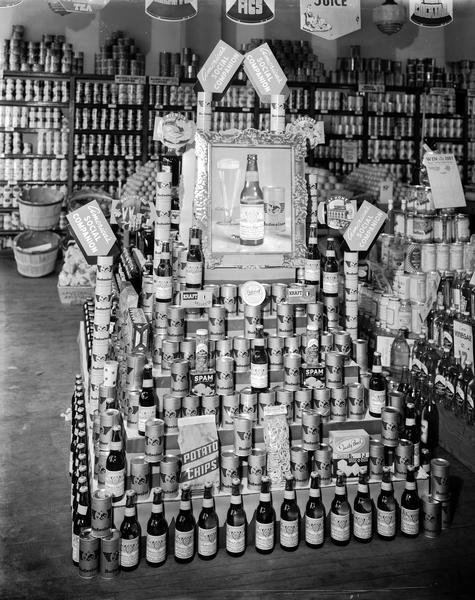 Budweiser beer and snack food display in Frank Fruit Company, 609-613 University Avenue. Sign says, "America's Social Companion".