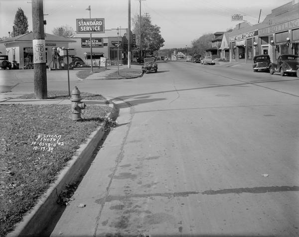 Looking west on University Avenue toward the intersection with Grand Avenue.  The Atkinson/Williams Standard Oil Service station, 2601 University Avenue and Corcoran's Tavern, 2605 University Avenue, are on the left.  Smart Motor Company, 2608 University Avenue, and Madison Nehi bottling, 2600 University Avenue, are on the right.