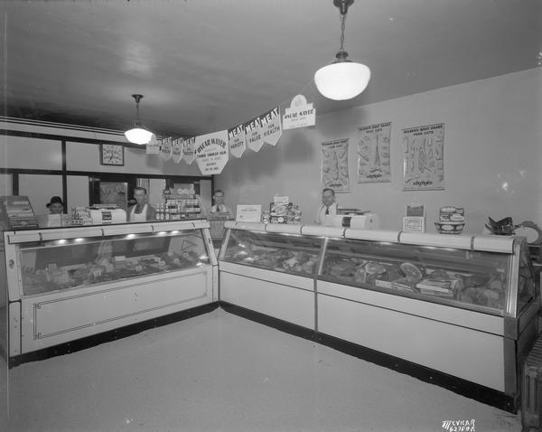 Four employees behind the meat counter in the North St. Meat Market (Jacobson's), 227 North Street.