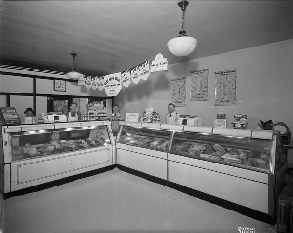 Four employees behind the meat counter in the North Street Market, 227 North Street.