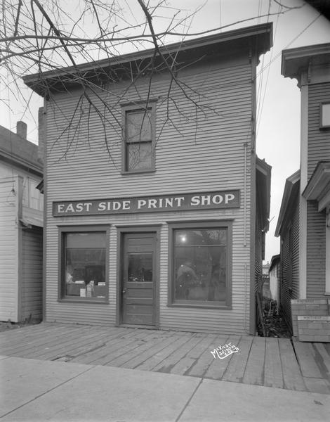 East Side Print Shop, 1982 Winnebago Street, publisher of East Side News. The address changed to 2008-2012 Winnebago Street in 1929. The business moved into another building at 2004 Winnebago Street, ca. 1930.