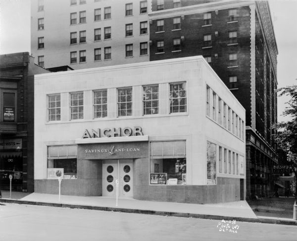 Anchor Savings and Loan Association, 2 South Carroll Street. The Loraine Hotel at 119-125 West Washington Avenue, is seen behind the Anchor building.