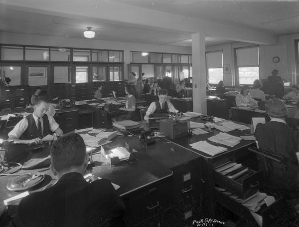 General view of large office area with workers at new office location of CUNA (Credit Union National Association), 1342 East Washington Avenue.