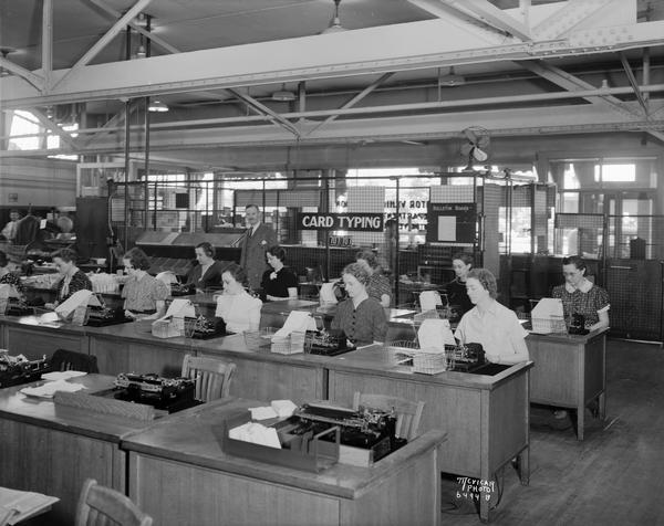 Wisconsin Auto License Bureau, 16-20 E. Doty Street, Card Typing Department, with women at typewriters and male supervisor.