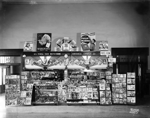Newsstand in the Chicago, Milwaukee, St. Paul & Pacific railway depot, 644 West Washington, displaying soft drinks, tobacco products, and reading materials.