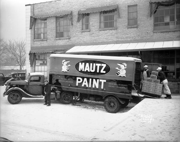 Men loading cases of paint into tractor-truck at Mautz Paint Co., 939 E. Washington Avenue.