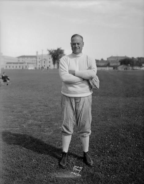 Portrait of Clarence W. "Doc" Spears, University of Wisconsin football coach, standing on the football field.
