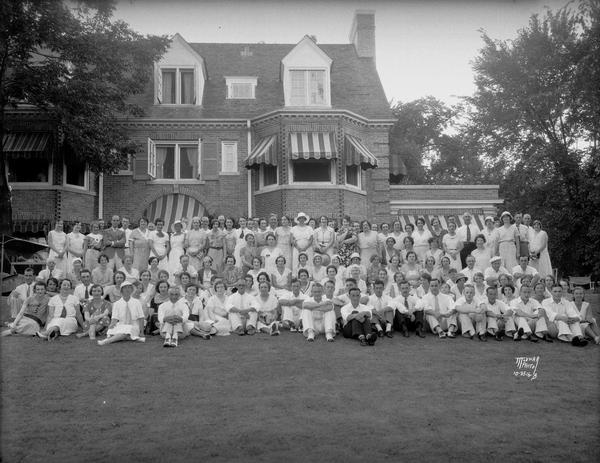 Group portrait of Manchesters employees in the yard of Harry Manchester's house, 531 Farwell Drive, Maple Bluff.