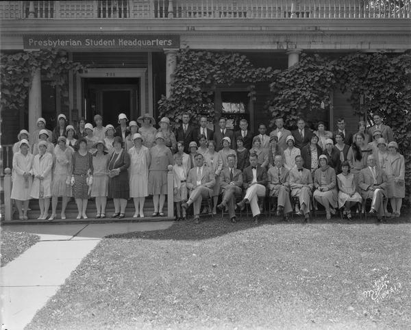 Group of students and adult sponsors in front of the Presbyterian Student Headquarters, 731 State Street.