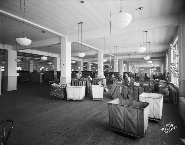 Men working in the U.S. Post Office sorting room, 215 Monona Avenue.