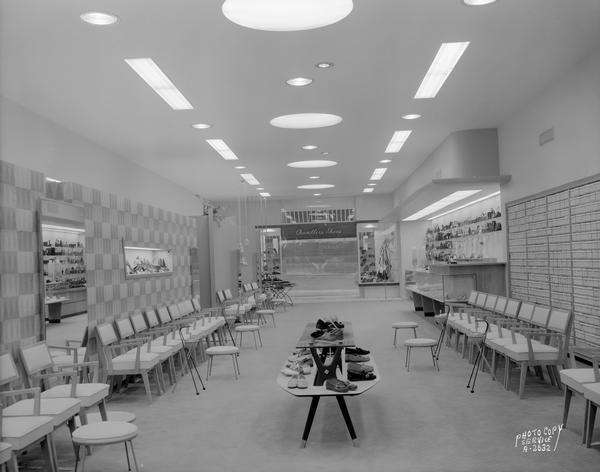 Interior of the Chandler's Shoes store, 10 West Mifflin Street, as seen from the rear, with small shoe display in the center of the store.