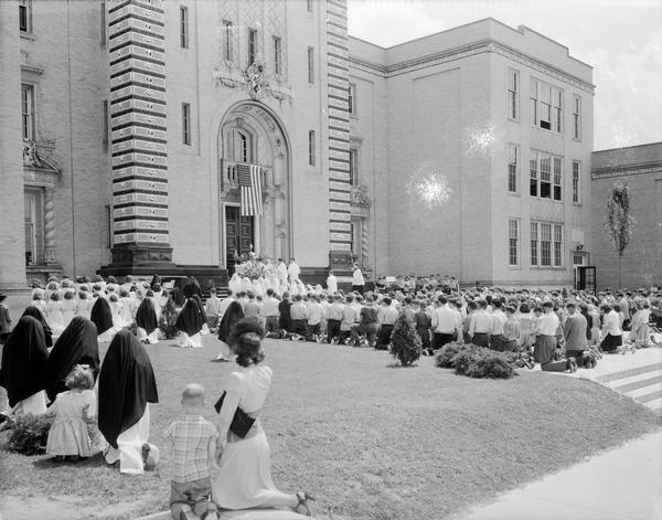 Students and nuns kneeling outside of Edgewood High School, 1000 Edgewood Avenue during the May Crowning Mass.