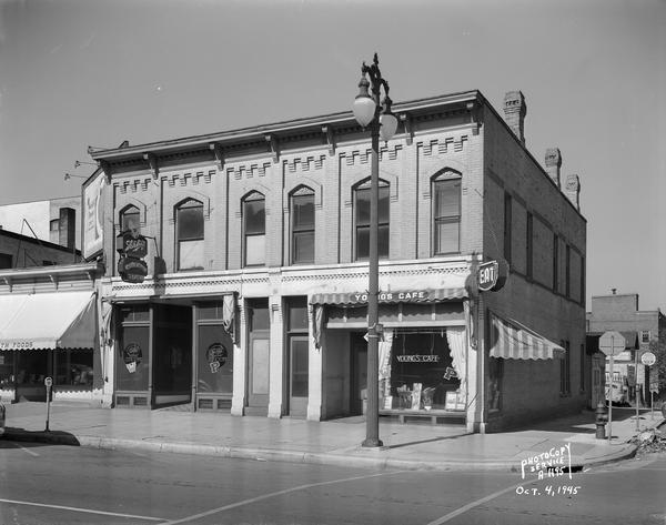 Exterior view of a building shared by the Club Royal Tavern and Young's Cafe at 122-124 East Washington Avenue.