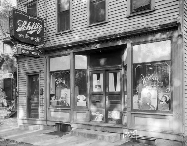 A neon Schlitz beer sign highlights an exterior view of Harold F. Reider's Jolly Tavern, 848 Williamson Street.