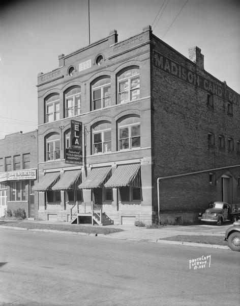 Vertical view of the Richard Ela Company, 744 Williamson Street selling industrial and welding equipment and supplies and Hanley Implement Company 740 Williamson Street, selling Allis Chalmers tractors and farm implements. Formerly the Madison Candy Company building, built in 1903.