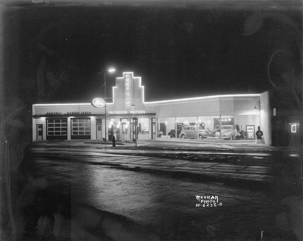 View at night of Olaf S. Jacobson Motors garage, 1501 Monroe Street, after Art Deco remodeling. The business was located on the corner of Regent and Monroe Streets.