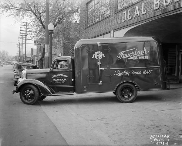 Fauerbach Lager Beer truck with "James Hepburn, Distributor, Decorah, Iowa" painted on the cab. The truck is parked just outside of the Ideal Body Company, 502 South Park Street.
