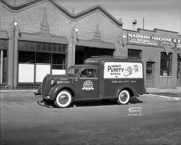 Gardner Bakery truck and driver parked in front of Madison Machine and Engine Company, 844 E. Washington Avenue. Taken for Diamond T Truck Sales.