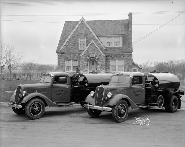 Two Lafayette County tar tank trucks park in front of Max Lehman's house, 1724 Park Street.