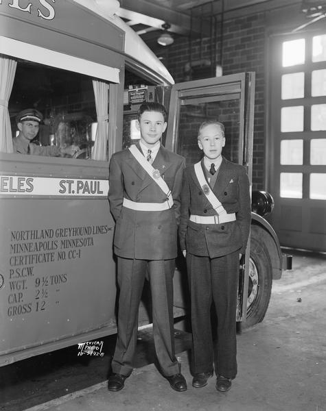 Harry Stiles and Converse Hettinger, two school safety patrol boys from Portage, Wisconsin, on their way to a national safety patrol conclave in Washington, D.C. They are standing in front of a Northland Greyhound bus.