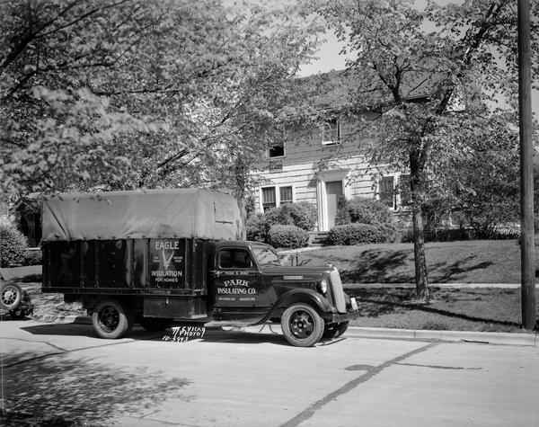Park Insulating Co. truck with Eagle insulation for homes, parked in front of a house.