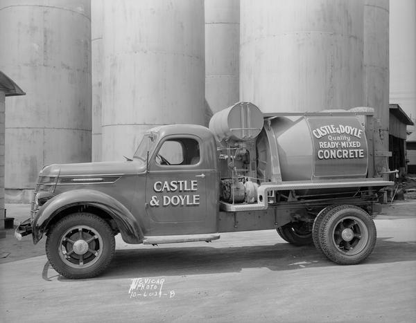Castle & Doyle Ready-mixed concrete truck parked in front of silos, 801 E. Main Street.