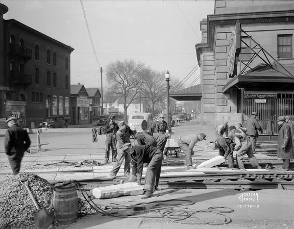 Construction crew working on a Chicago & Northwestern Railroad crossing, looking northwest along the 100 block of South Blair Street.
