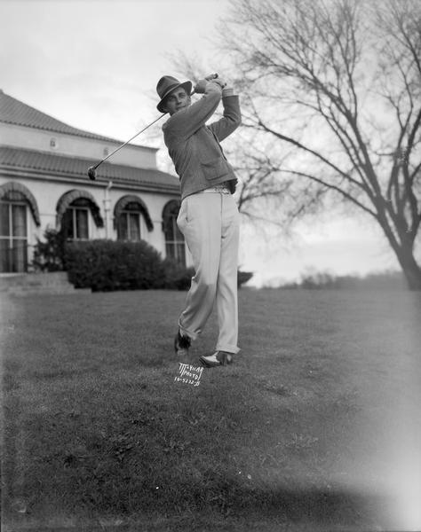 Kully Schlicht posing on his follow through of a golf swing.